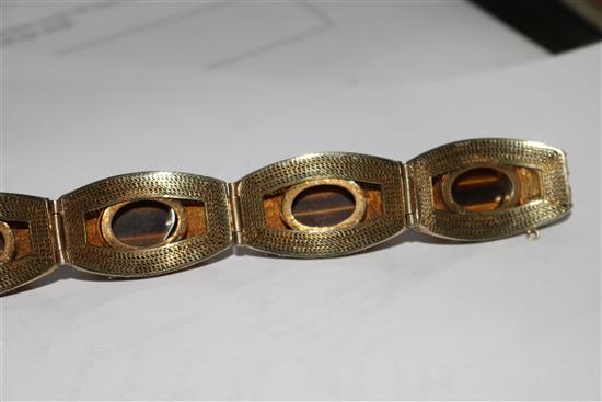 A Chinese silver gilt filligree and cabochon tigers eye quartz set bracelet, 73mm.